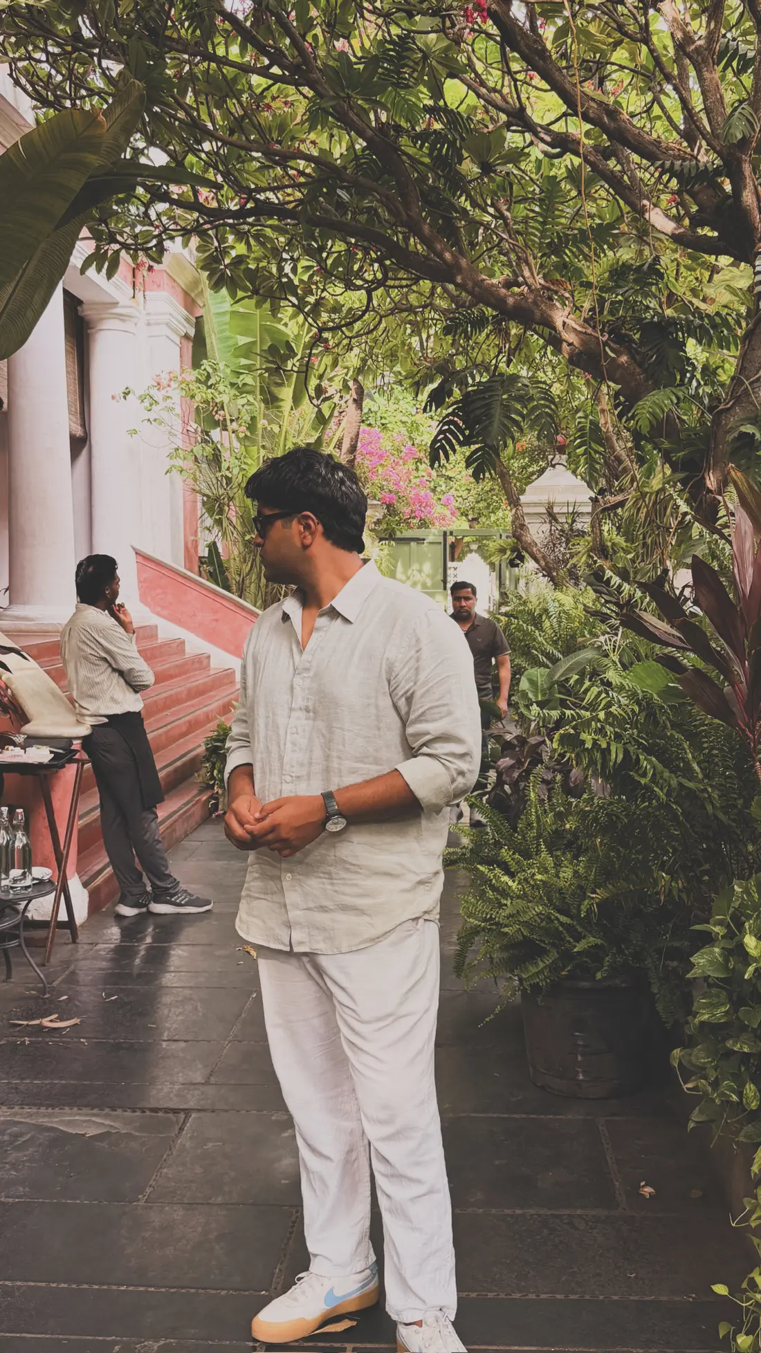 Dev standing in a warm courtyard